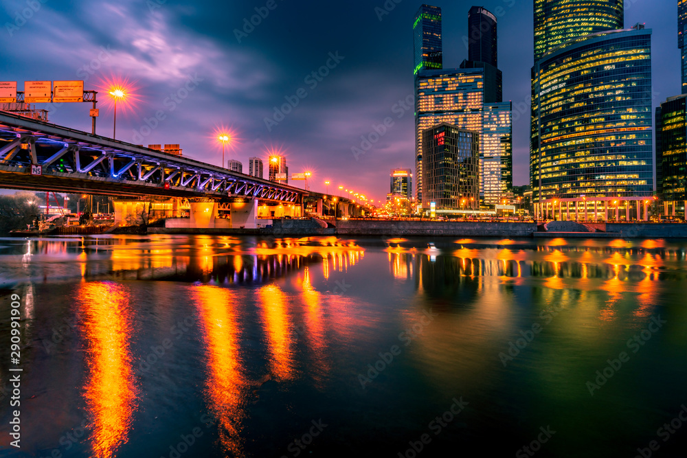 Fototapeta premium Beautiful cityscape panorama with illuminated bridge and skyscrapers at night