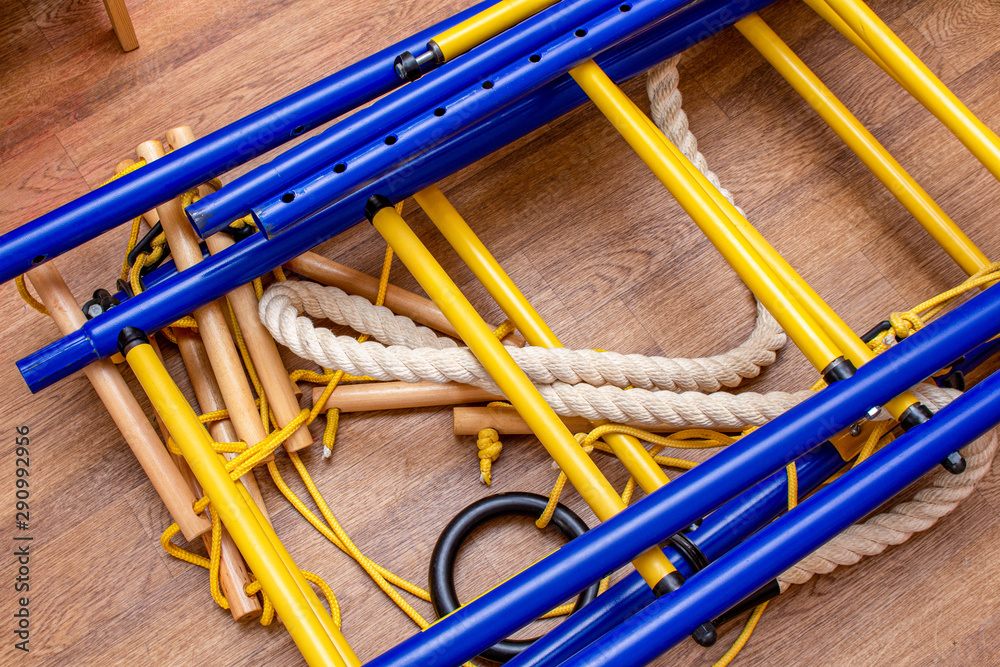 Disassembled home gymnastic wall bars on the floor. Sport gym home concept Disassembled home gymnastic wall bars on the floor. Sport gym home concept