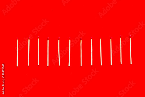 Symbol of danger with matches on red background top view