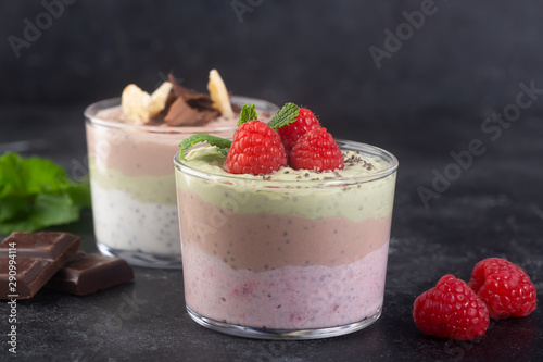 Chia seed pudding with three flavors, cocoa, matcha and strawberry with yoghurt, chocolate and mint leaves. Horizontal orientation photo