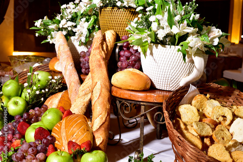 Composition with groceries in wicker basket on kitchen table