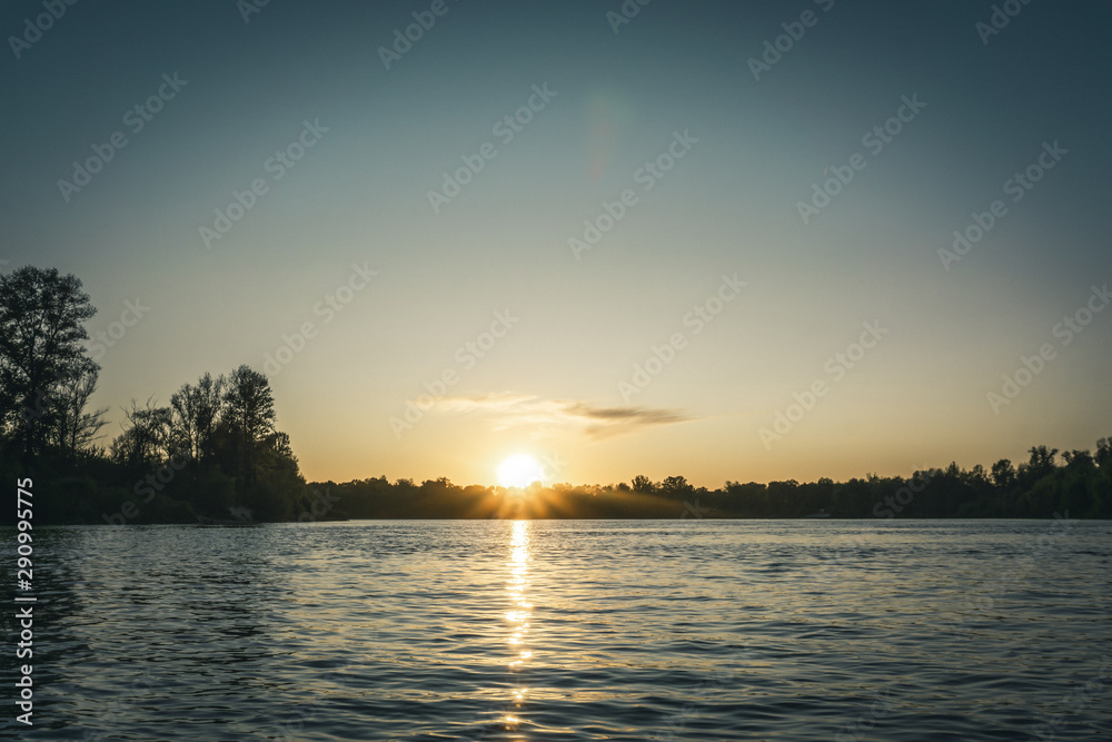 Swimming on kayaks. Rear view of kayaking on Desna river together with beautiful clouds in the backgrounds Swimming on kayaks. Rear view of kayaking on Desna river together with beautiful clouds in the backgrounds