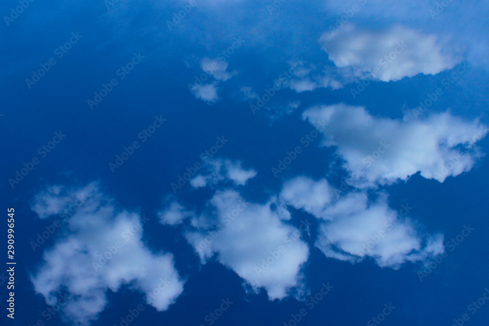 White clouds in the blue sky. Beautiful sky background. Freedom, nature, landscape concept.