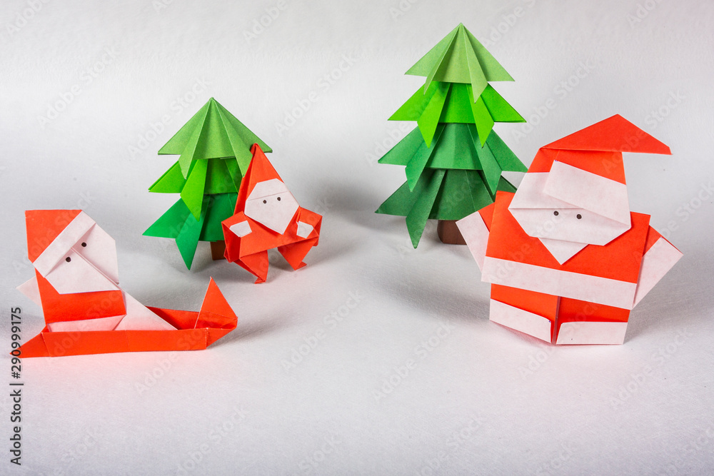 New Year card handmade origami figures. Christmas concept winter crafted decorations studio shot ISOLATED santa claus origami