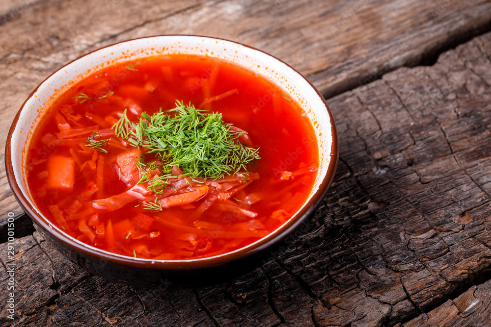 Ukrainian traditional dish borsch on a wooden board Ukrainian traditional dish borsch on a wooden board