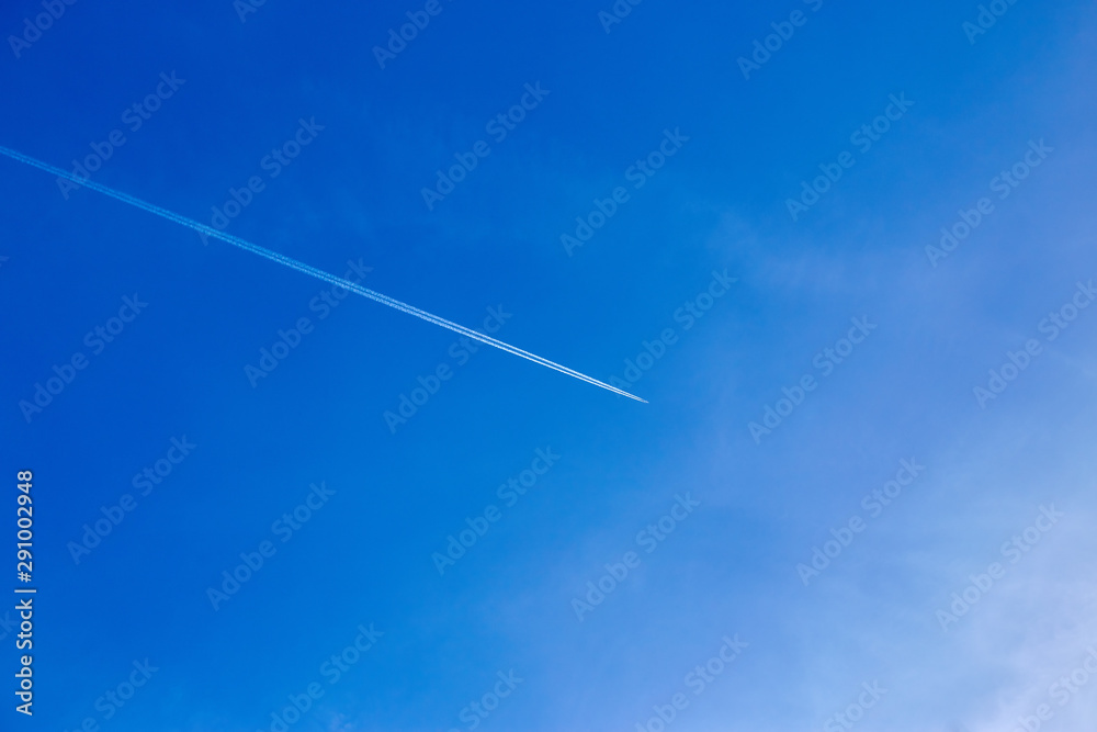 An airplane flying in the blue sky An airplane flying in the blue sky