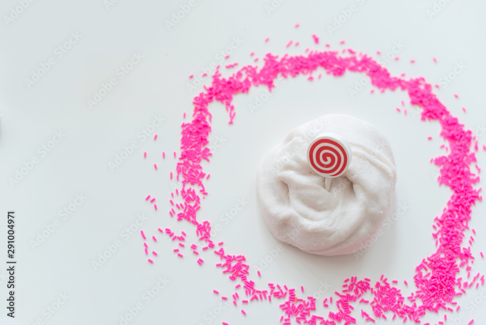 hand made toy called slime. white slime and pink sprinkles. 