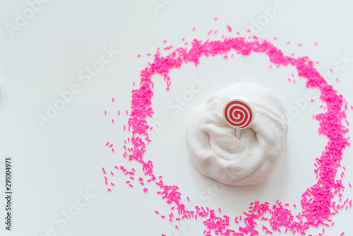 hand made toy called slime. white slime and pink sprinkles. 