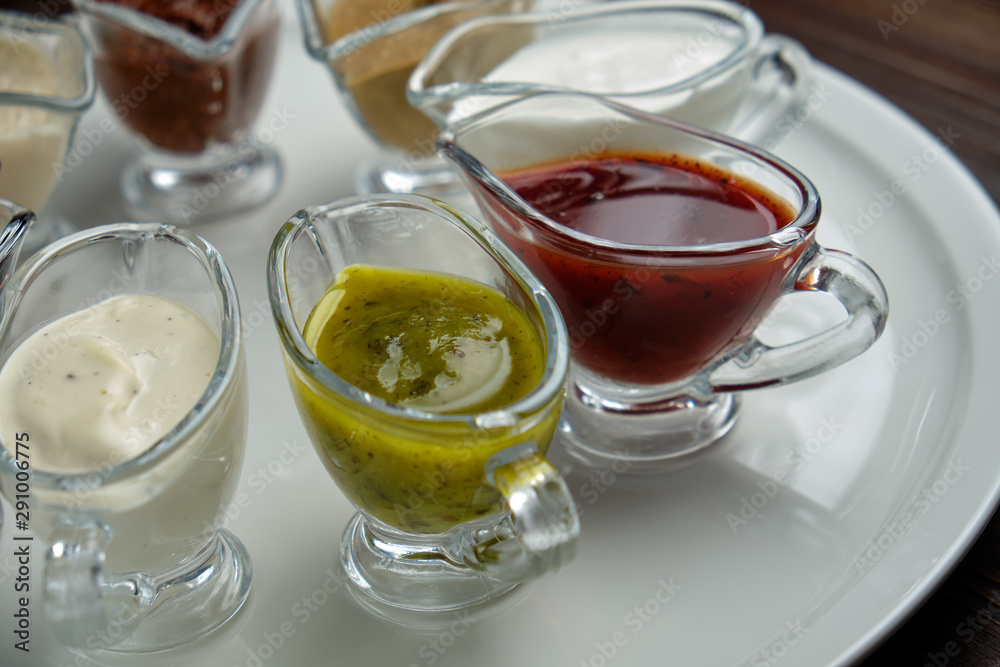 sauces in bowls on a dark wooden background. menu for catering sauces in bowls on a dark wooden background. menu for catering