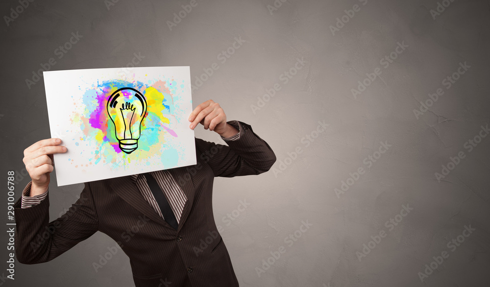 Person holding a paper with a drawn colorful idea concept Person holding a paper with a drawn colorful idea concept