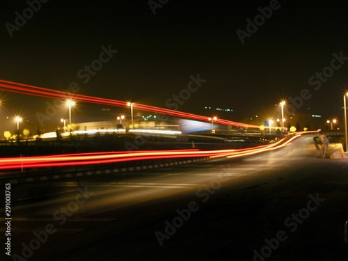 long exposure photography of road while cars are passing and leaving rays of lights