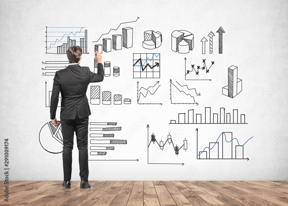 Businessman drawing infographics at wall Businessman drawing infographics at wall