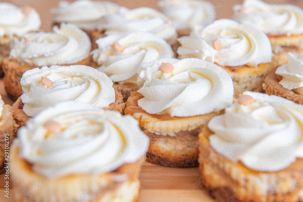 small rounded cakes with pumpkins and white meringue small rounded cakes with pumpkins and white meringue