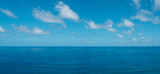 blue sky with clouds over water - ocean horizon , sea background -