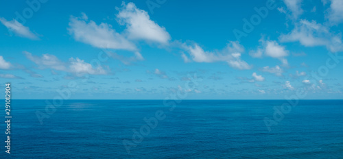 blue sky with clouds over water - ocean horizon , sea background -