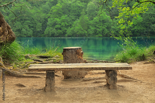 Wooden bench and picturesque view of beautiful lake