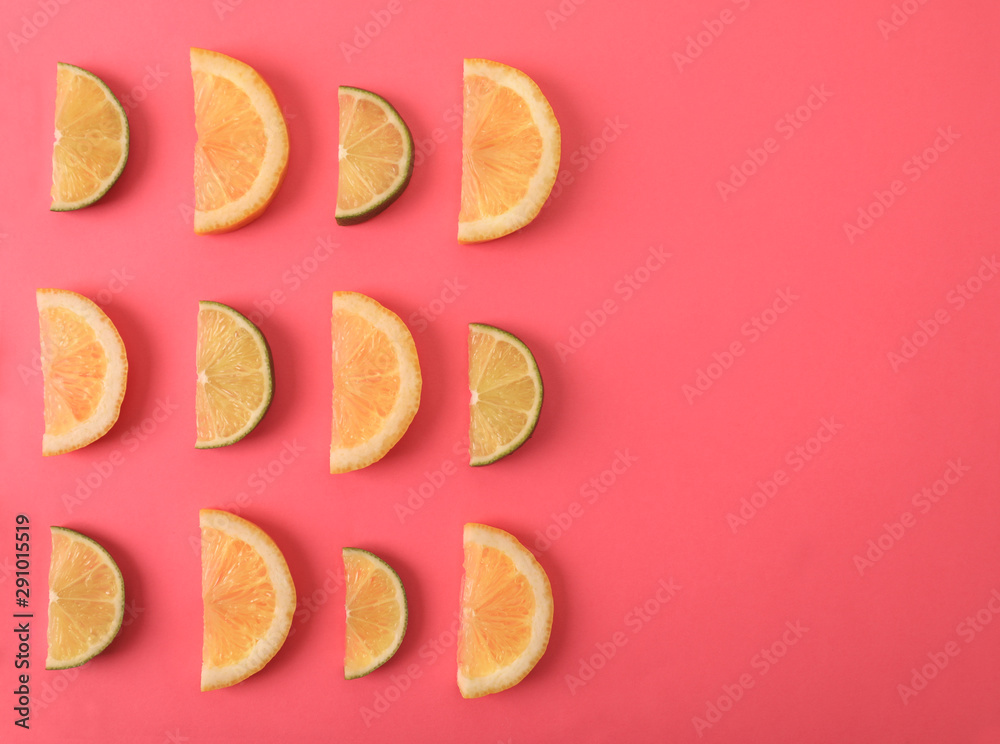 Flat lay composition with slices of  juicy exotic fruits on pink background. Space for text