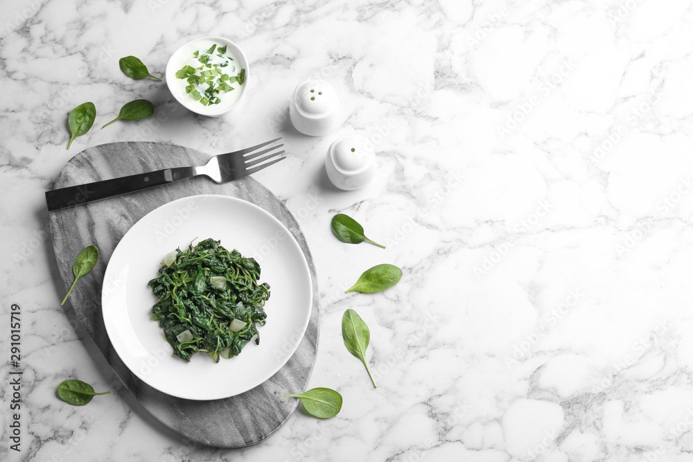 Flat lay composition with cooked spinach and space for text on white marble table. Healthy food Flat lay composition with cooked spinach and space for text on white marble table. Healthy food