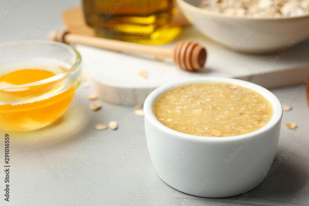 Handmade face mask and different ingredients on grey stone background, closeup Handmade face mask and different ingredients on grey stone background, closeup