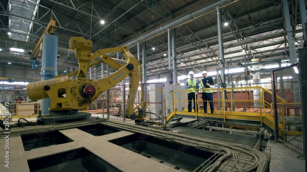 Technicians, colleagues work at a brick plant, checking machines. Technicians, colleagues work at a brick plant, checking machines.