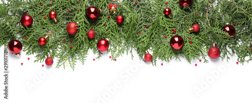 Thuja branches with Christmas decorations on white background, flat lay