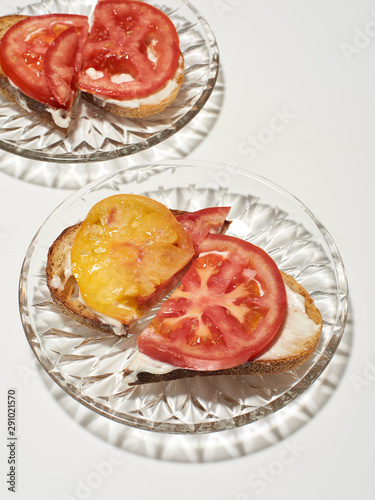 Tomato toast on glass plates photo