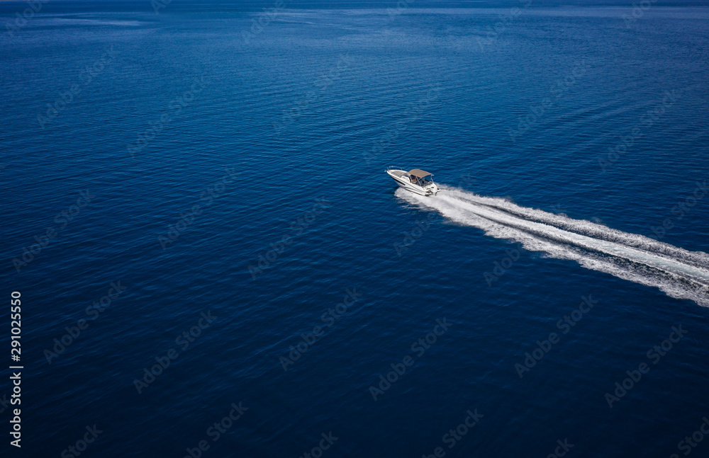 Naklejka premium Aerial view of speed motor boat on open sea