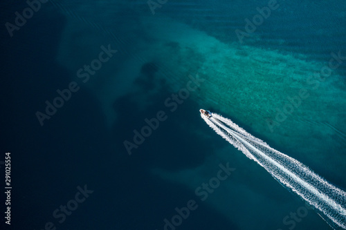 Aerial view of speed motor boat in shallow water