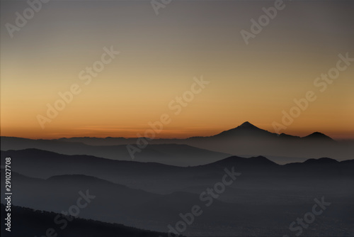 Pico de Orizaba Volcano as the sun rises over the mountain range photo