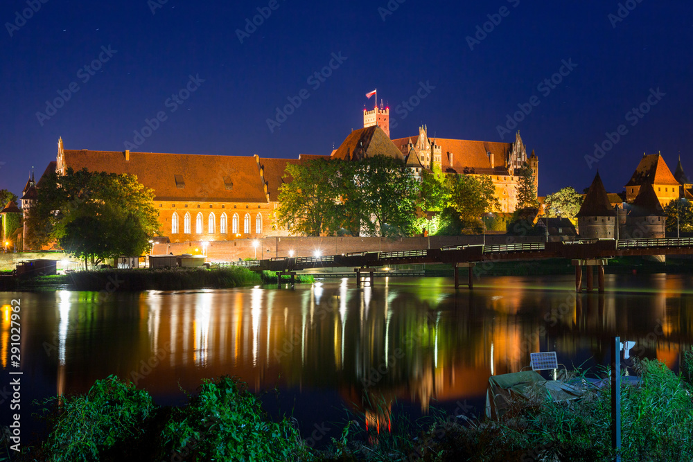 Malbork castle over the Nogat river at night, Poland