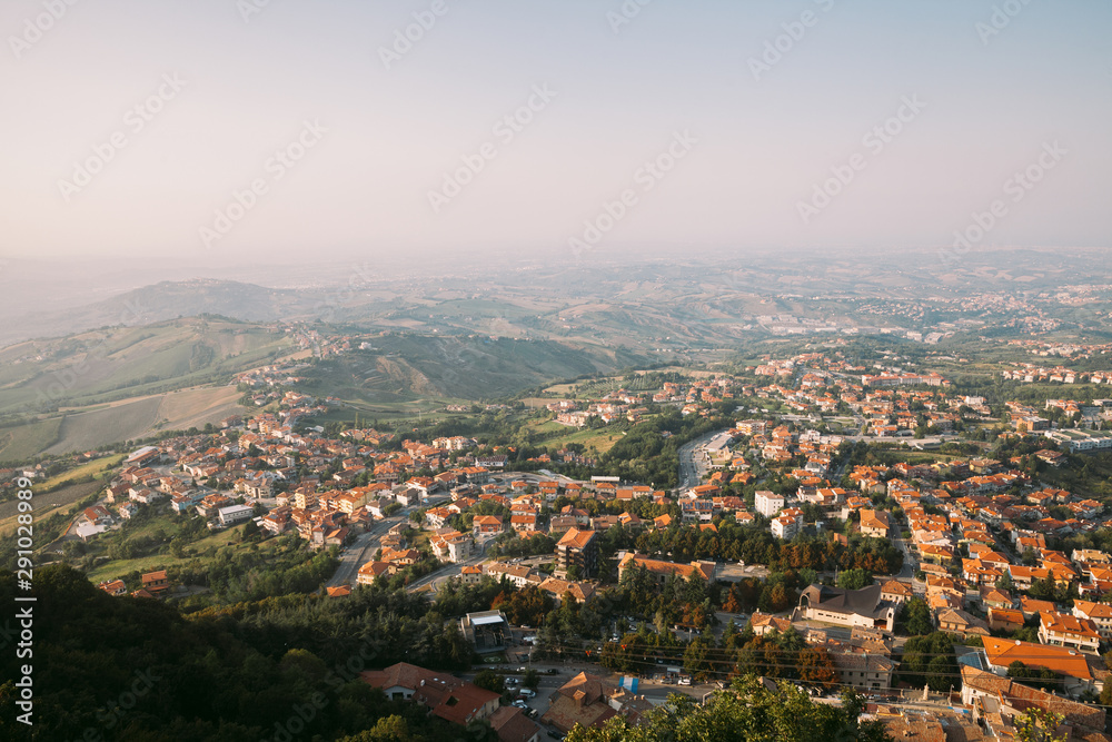 View from the top of San Marino castle. San Marino suburban districts and Italian hills view from above. Panorama of San Marino and Italy from Monte Titano.