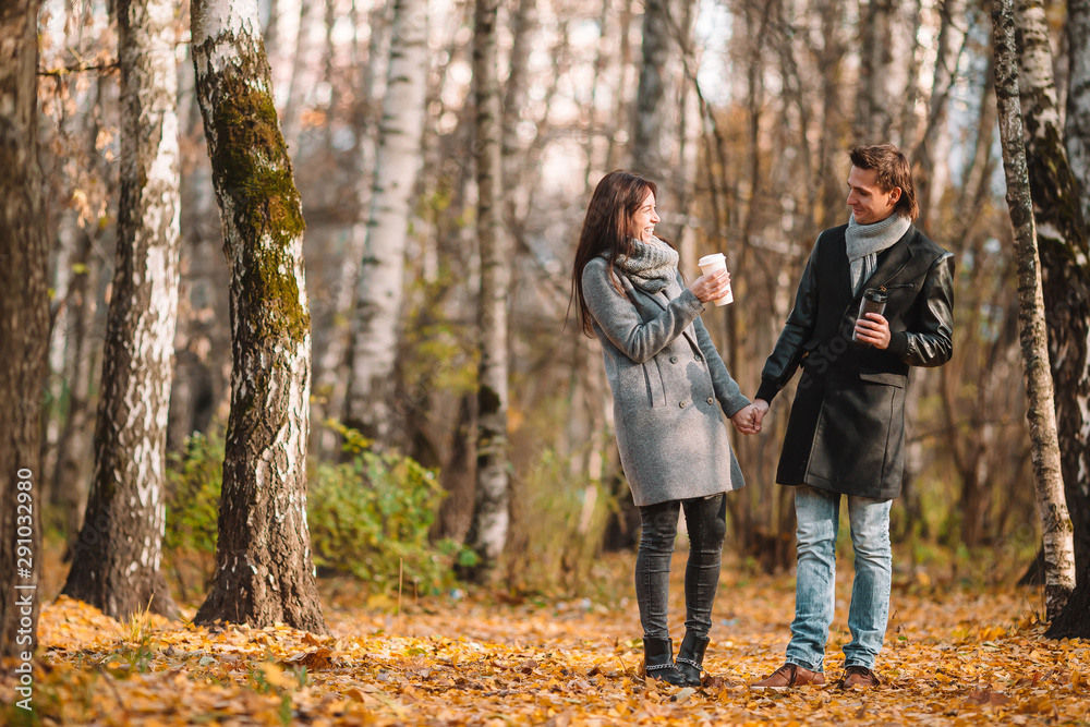 Happy family walking in autumn park on sunny fall day Happy family walking in autumn park on sunny fall day
