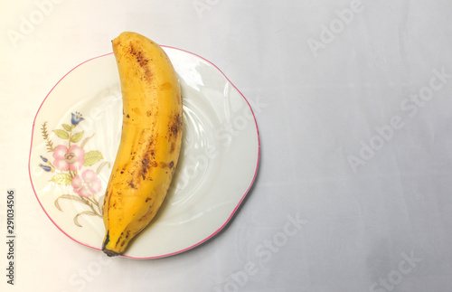 Pomegranate with banana and orange on white background