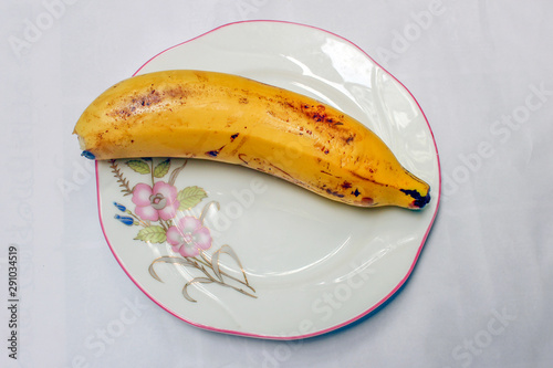 Pomegranate with banana and orange on white background