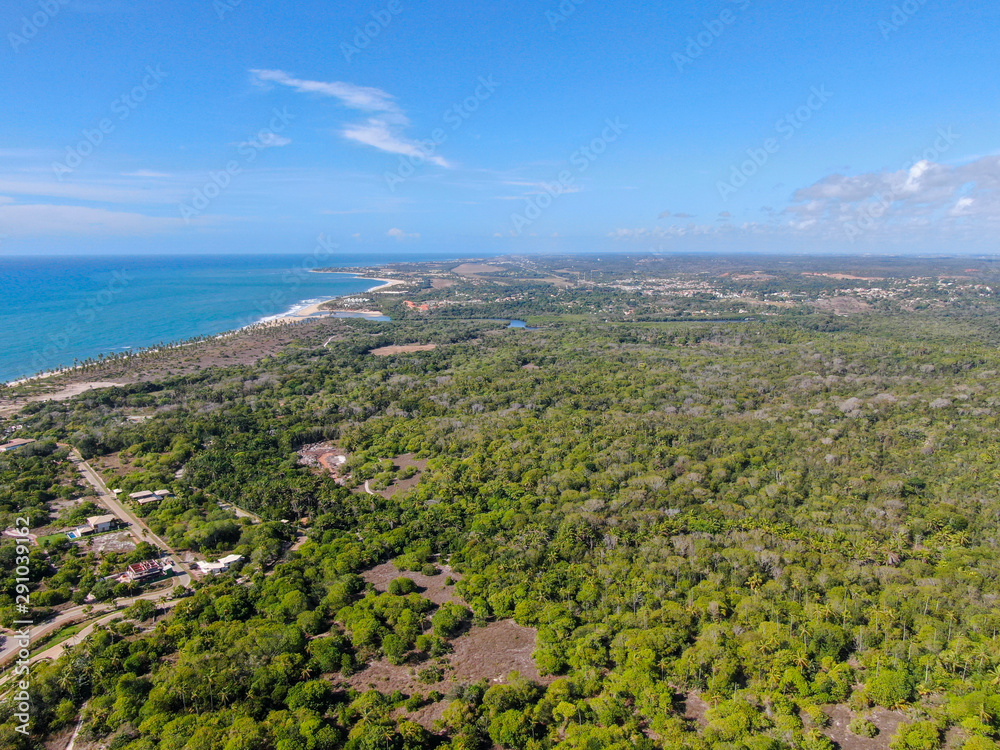 Aerial view of Praia Do Forte coastline town with blue ocean