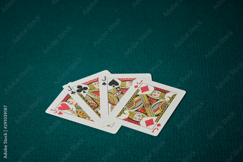 Φωτογραφία play of poker of jacks deployed the cards on green carpet of background