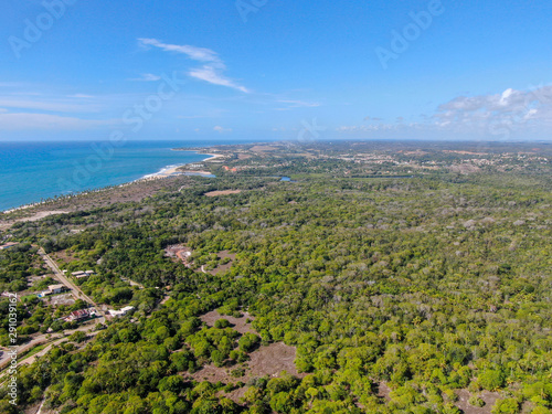 Aerial view of Praia Do Forte coastline town with blue ocean © Unwind