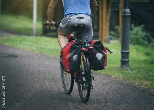 Man riding bike with rear seat bags