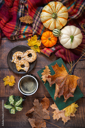 Autumn background. Decorative pumpkins, leaves . coffee and cookies on wooden background.top view. © Elena