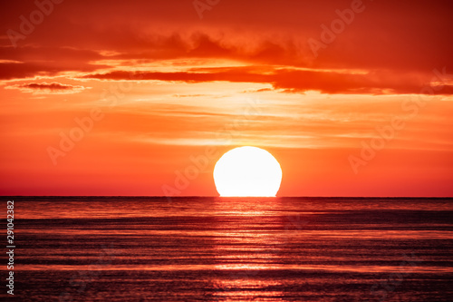 Fototapeta Naklejka Na Ścianę i Meble -  Beautiful red and orange sunset over the sea. The sun goes down over the sea.