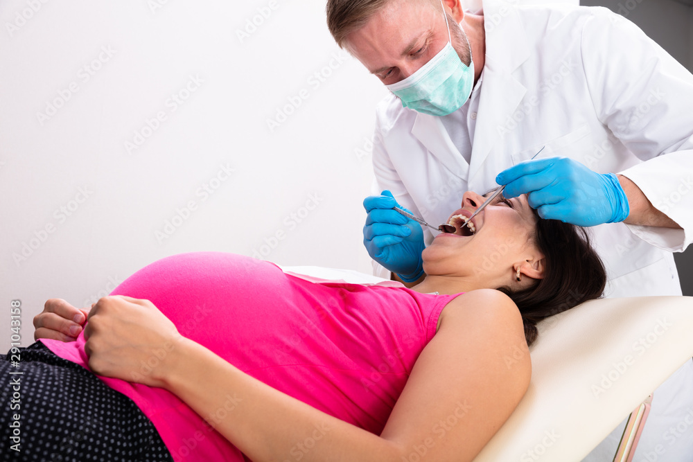 Fototapeta premium Pregnant Woman Having Teeth Examined At Dentists