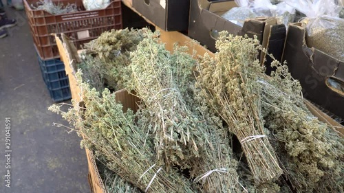 Dried thyme and oregano at Greek local market. Handheld. Soft focus photo