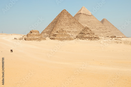 Horse drawn carts near Giza pyramids. Khufu  Khafre  Menkaure and pyramids Queens