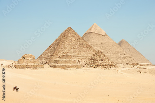 Horse drawn carts near Giza pyramids. Khufu, Khafre, Menkaure and pyramids Queens
