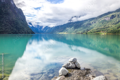 clouds and the stones on Oldenvatnet lake in Norway photo