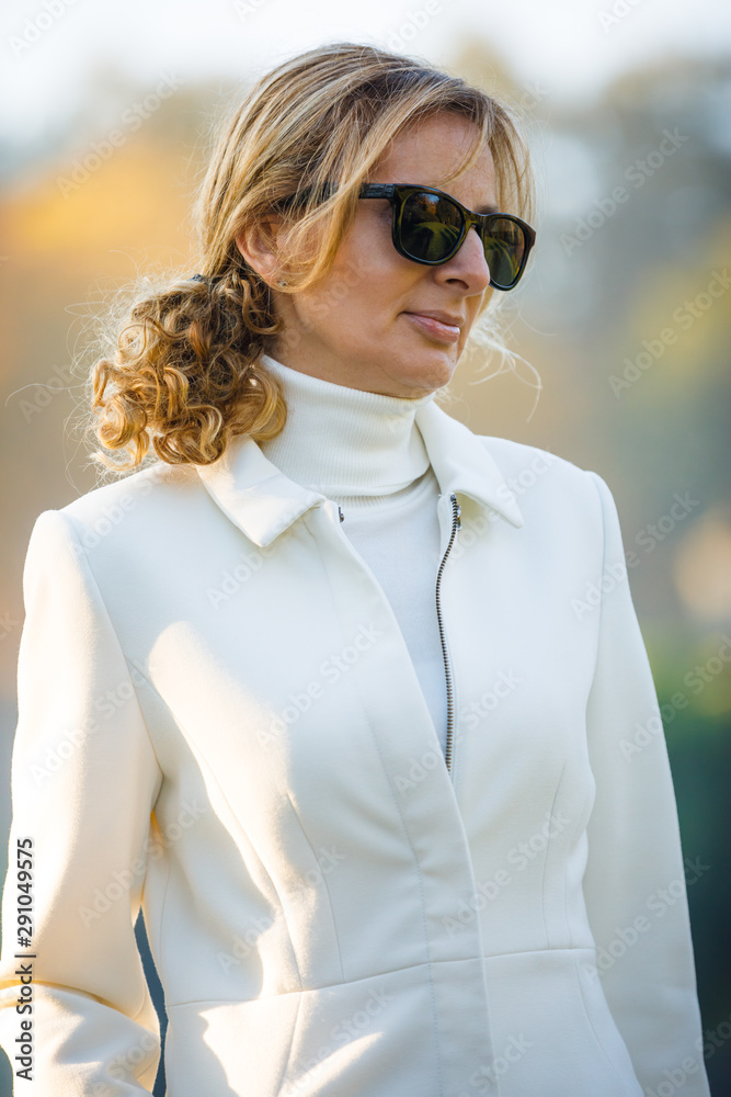 Middle-aged woman walking in city park