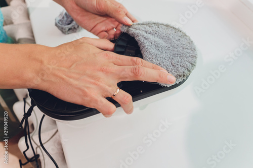 Vacuum cleaner robot cleaning window in high building outdoor. photo