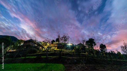 Time-lapse of transition from day to night over the village houses in Himachal Pradesh, India photo