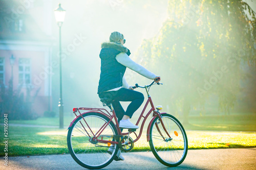 Urban biking - woman riding bike in city park © Jacek Chabraszewski