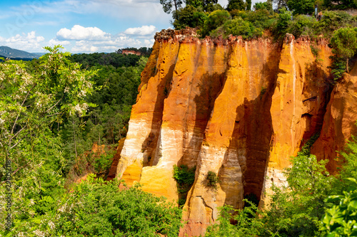 Large colorful ochre deposits, located in Roussillon, small Provensal town in Natural Regional Park of Luberon, South of France